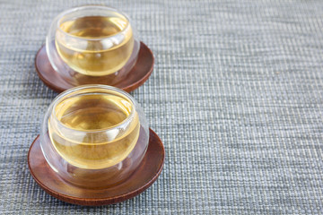 Herbal rosemary tea in a glass cup on oriental background, horizontal, copy space