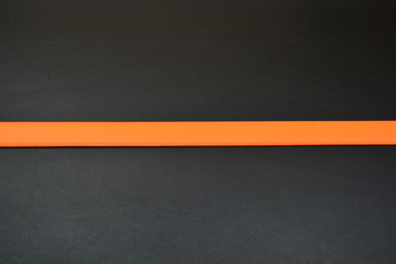Fototapeta premium Orange belt on black background