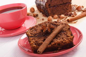 Dark cake with chocolate, cocoa and plum jam, cup of coffee, delicious dessert