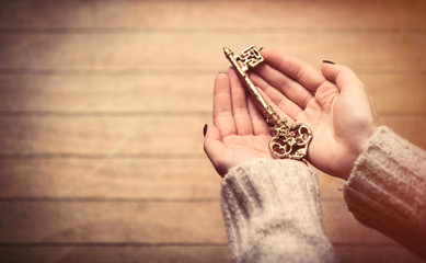 hands holding key