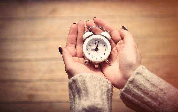 Hands Holding Clock