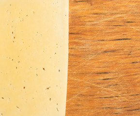 Sliced Cheese Over Rustic Wooden Background