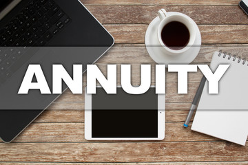 Naklejka premium Tablet on desktop with annuity text.