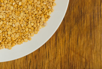 Heap of Dry Split Yellow Peas in White Round Plate