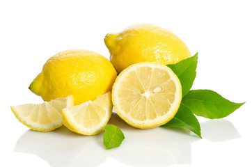 Two lemons and half with leaves  isolated on white background