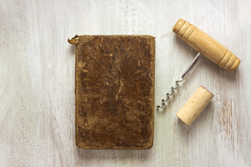 Old notebook, corkscrew, and cork, with copyspace