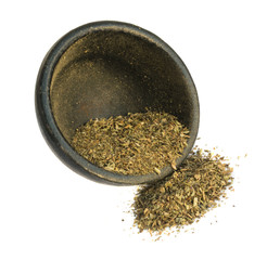 Heap of Dried Basil Flakes in Black Round Bowl Isolated