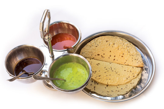 Indian bread served with traditional assortment of sauces