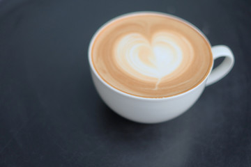 Vintage latte art coffee. Heart shape latter art in white cup