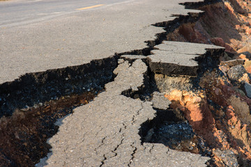 Side of the broken asphalt road collapsed and fallen