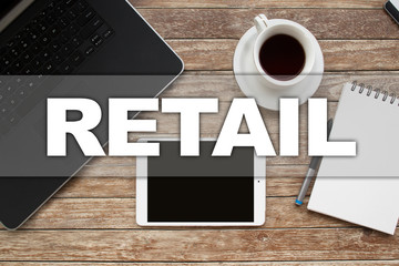 Naklejka premium Tablet on desktop with retail text.