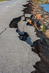 Side of the broken asphalt road collapsed and fallen