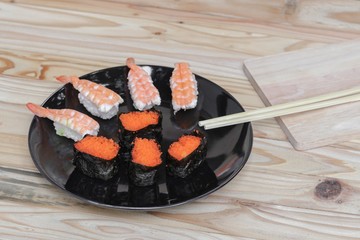 Sushi Close up in black plate on wooden background, Asian food delicious