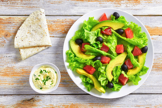 slamon salad with sauce and pita, top view