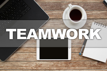 Naklejka premium Tablet on desktop with teamwork text.