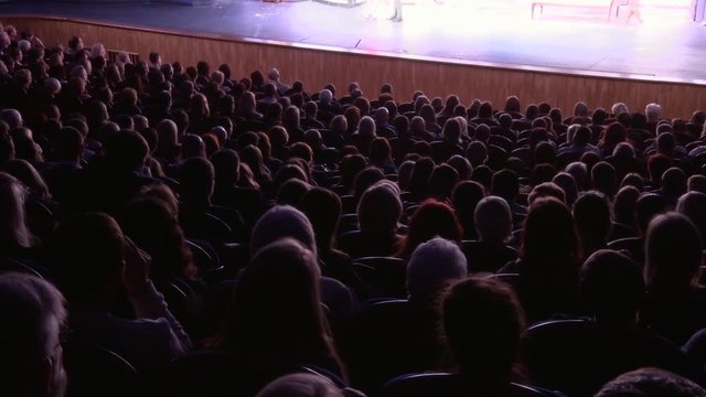 The audience in the theater during the performance. Time-lapse recording.