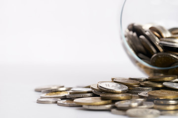 Business finance. Save money for investment concept.Different coins money in the glass piggy box with copy space