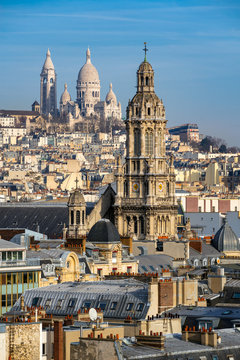 Rooftops of Paris with the Sacre Coeur Basilica in Montmartre and Trinity Church. 18th Arrondissement, Paris, France