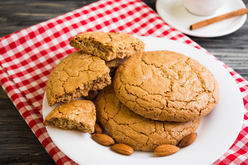 Cookies with almonds on a white plate. Tasty dessert.
