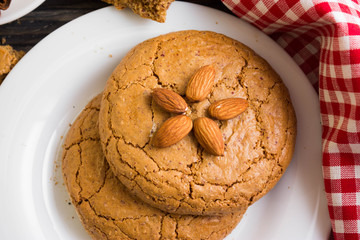 Cookies with almonds on a white plate. Tasty dessert.