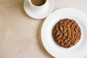 Oatmeal cookies with chocolate on a white plate. Tasty dessert.