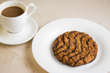 Oatmeal cookies with chocolate on a white plate. Tasty dessert.