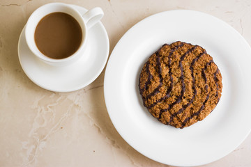 Oatmeal cookies with chocolate on a white plate. Tasty dessert.