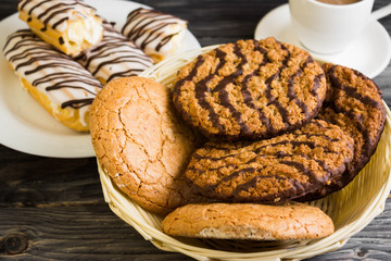 Oatmeal cookies with chocolate and cookies with almonds in a basket