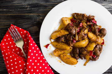 Fried chicken gizzards on a wooden background in rustic style