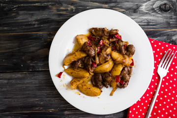 Fried chicken gizzards on a wooden background in rustic style