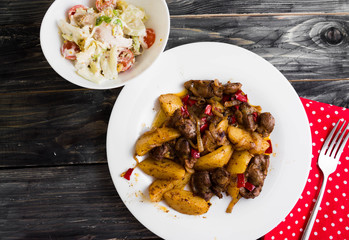 Fried chicken gizzards on a wooden background in rustic style