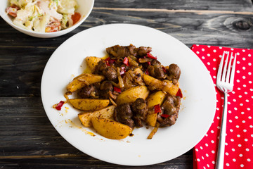 Fried chicken gizzards on a wooden background in rustic style