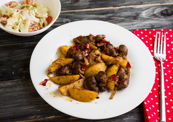 Fried chicken gizzards on a wooden background in rustic style