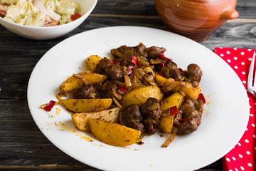 Fried chicken gizzards on a wooden background in rustic style