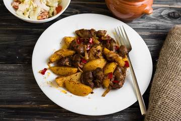 Fried chicken gizzards on a wooden background in rustic style