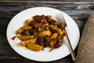 Fried chicken gizzards on a wooden background in rustic style