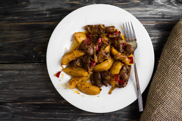 Fried chicken gizzards on a wooden background in rustic style