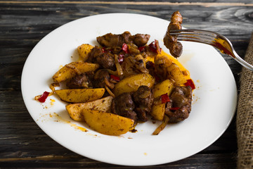 Fried chicken gizzards on a wooden background in rustic style