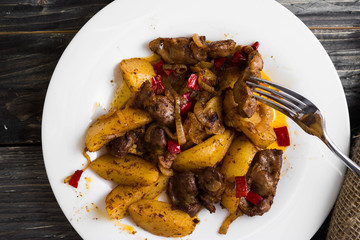 Fried chicken gizzards on a wooden background in rustic style