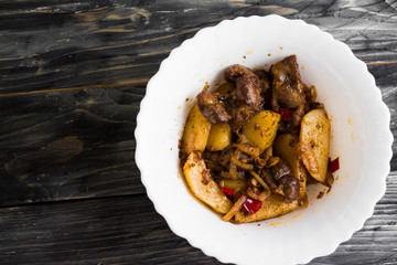 Fried chicken gizzards on a wooden background in rustic style