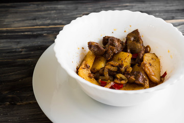 Fried chicken gizzards on a wooden background in rustic style