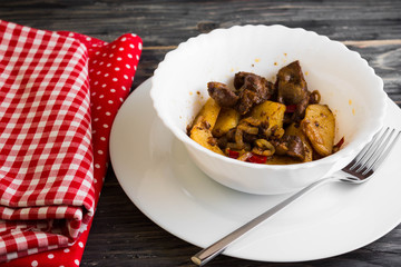 Fried chicken gizzards on a wooden background in rustic style