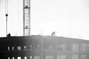 builders working on the construction site, erecting and concrete reinforcement, workflow construction, silhouette