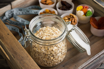 Nuts and dried fruits in a box on a wooden table in rustic style