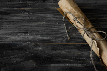 Wooden background in rustic style with ancient scroll