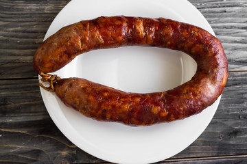 Homemade sausage on a wooden table in a rustic style. A delicious dish.