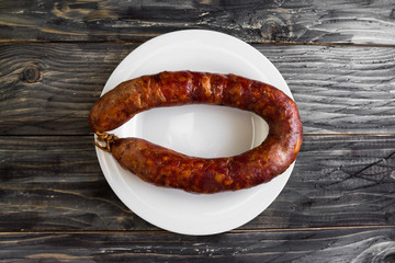 Homemade sausage on a wooden table in a rustic style. A delicious dish.
