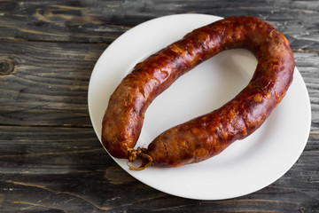 Homemade sausage on a wooden table in a rustic style. A delicious dish.
