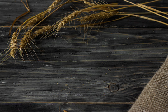 Background with wheat spikelets and sackcloth in a rustic style