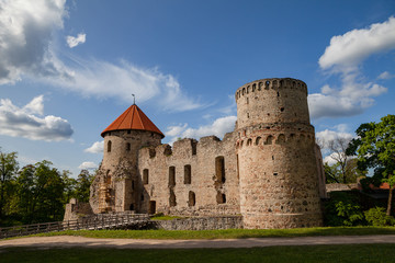 View of beautiful ruins of ancient Livonian castle in old town of Cesis, Latvia. Greenery and summer daytime.